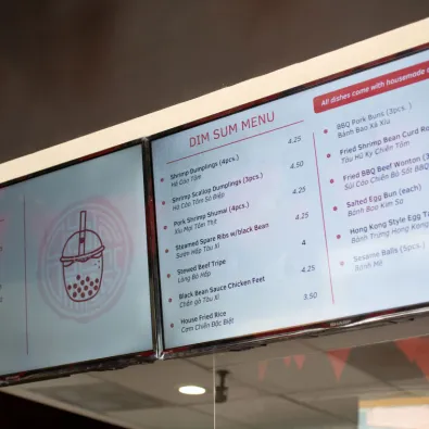 A dim sum menu on a digital screen in a restaurant