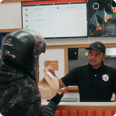 A delivery driver speaking with an IRO Sushi employee