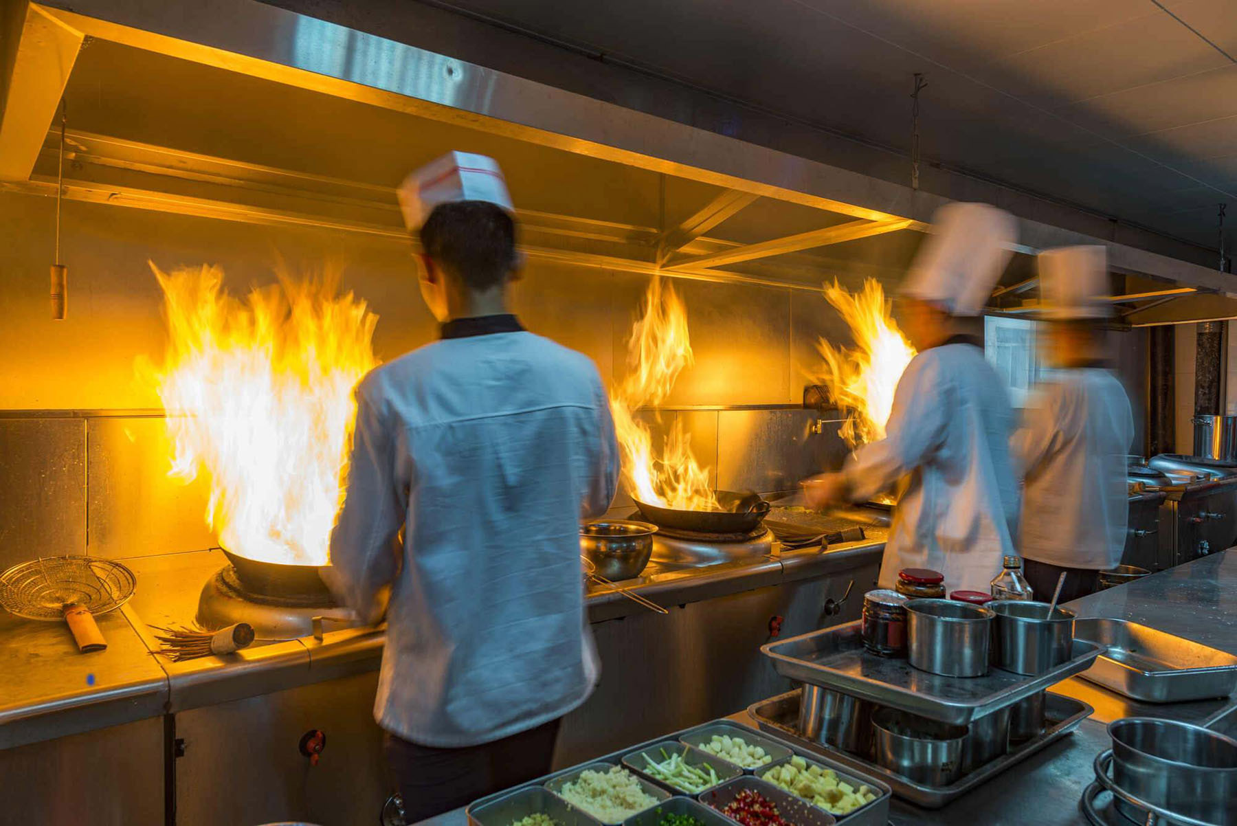 chefs in a kitchen working efficiently because of controlled order capacity management