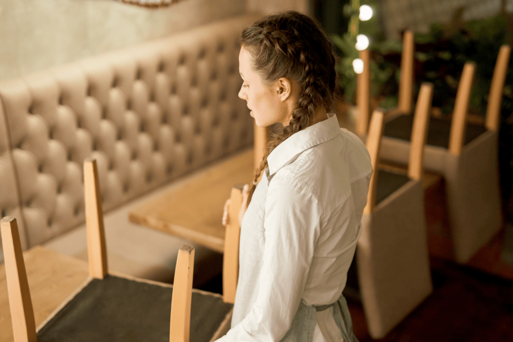 Backing local heroes in tough times - Waitress holding chair