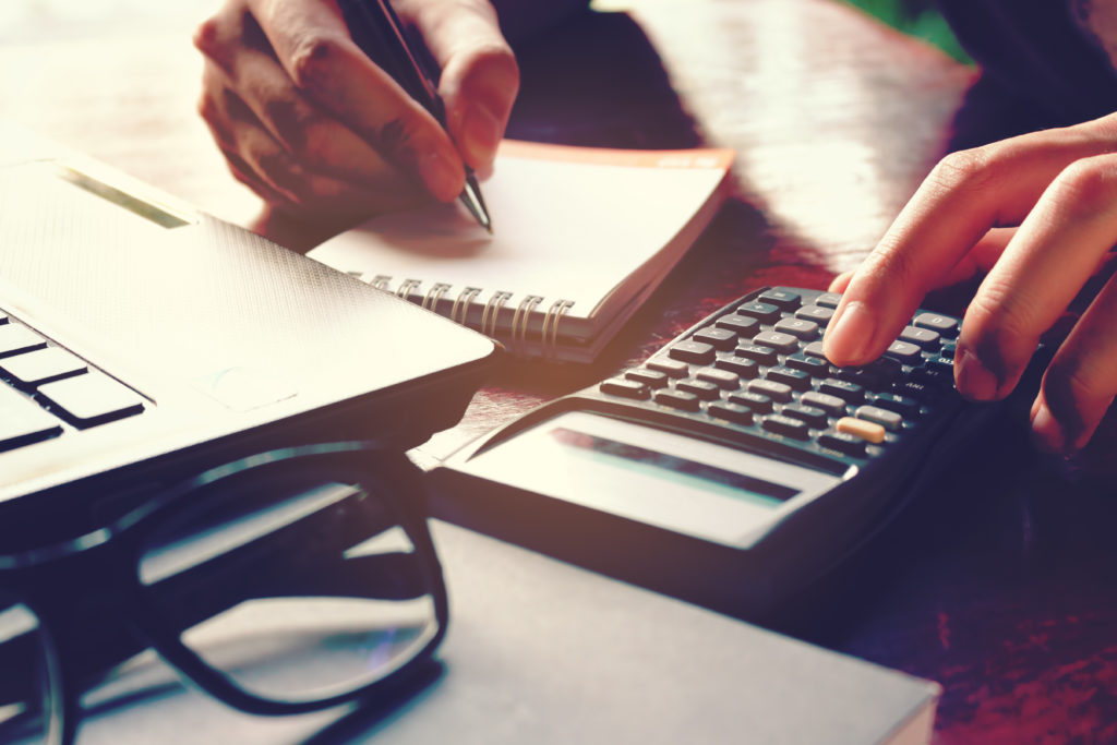 a man doing calculations on a calculator - looking for the right digital ordering solution for your restaurant