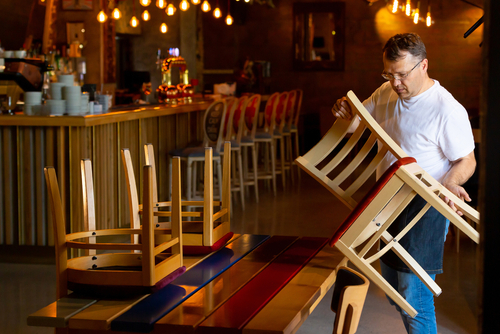 A man prepairing to open his restaurant before service